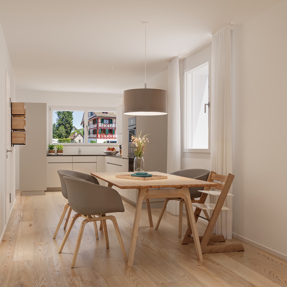 Visualisierung: Küche mit Essbereich und Blick auf das Riegelhaus gegenüber